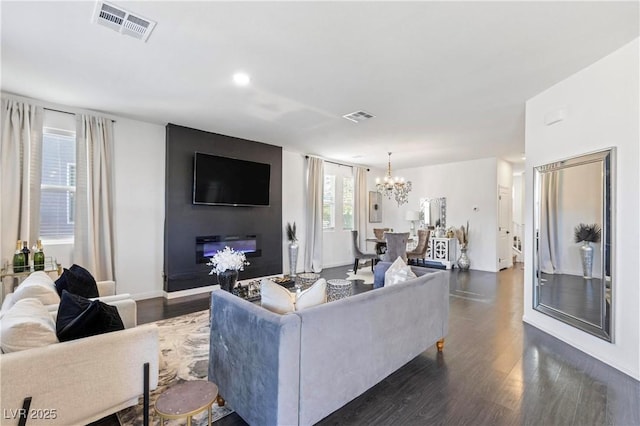 living room with dark hardwood / wood-style floors and a chandelier