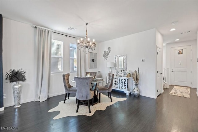 dining area with an inviting chandelier and dark hardwood / wood-style floors