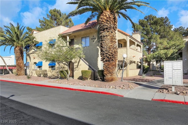 view of side of property featuring mail boxes