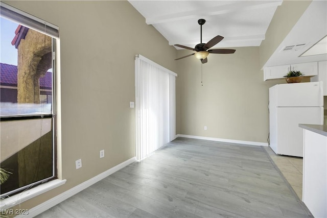 interior space featuring a healthy amount of sunlight, beam ceiling, ceiling fan, and light hardwood / wood-style floors