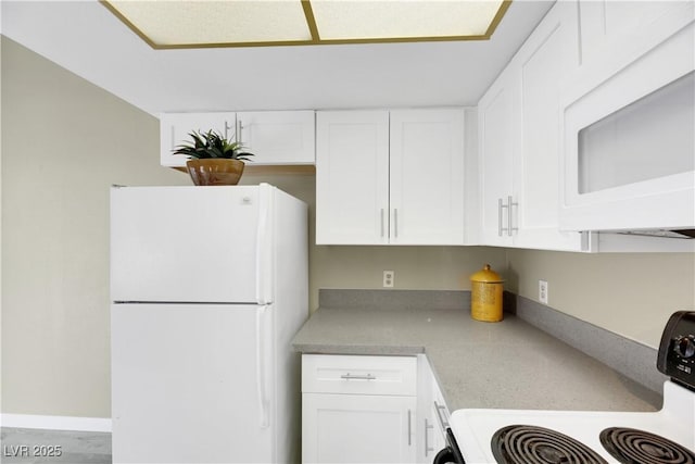 kitchen featuring white appliances and white cabinets