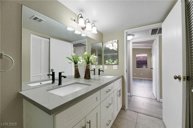 bathroom with tile patterned flooring and vanity