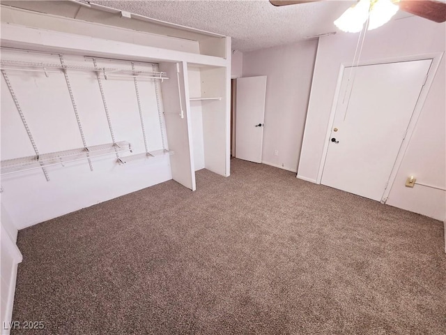 unfurnished bedroom with ceiling fan, carpet, and a textured ceiling