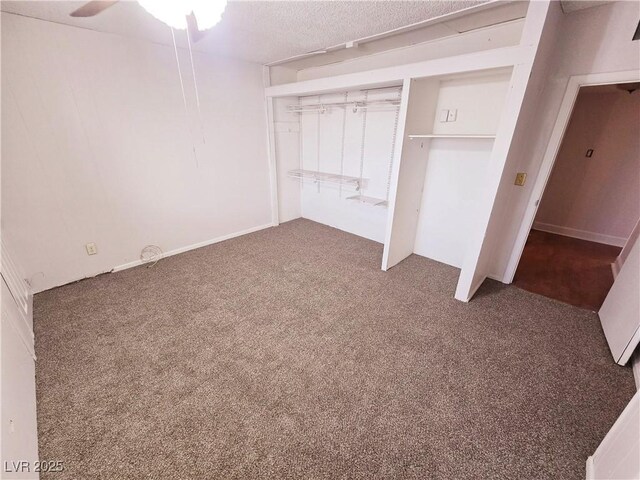 unfurnished bedroom with dark carpet, a closet, and ceiling fan