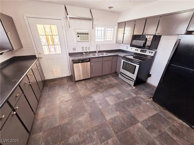 kitchen with a wall mounted air conditioner, sink, and black appliances