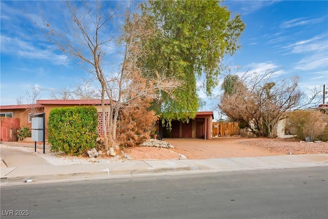 view of front of house with fence and concrete driveway