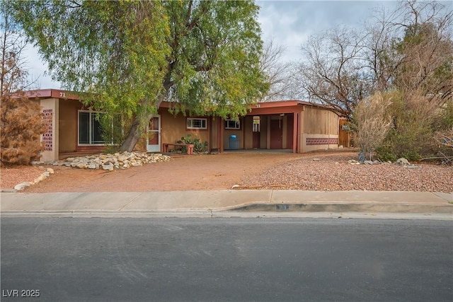 view of front facade with driveway and an attached carport