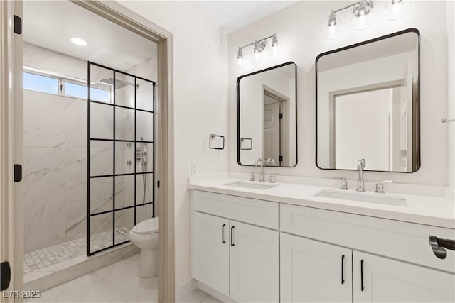 bathroom featuring toilet, a tile shower, and vanity