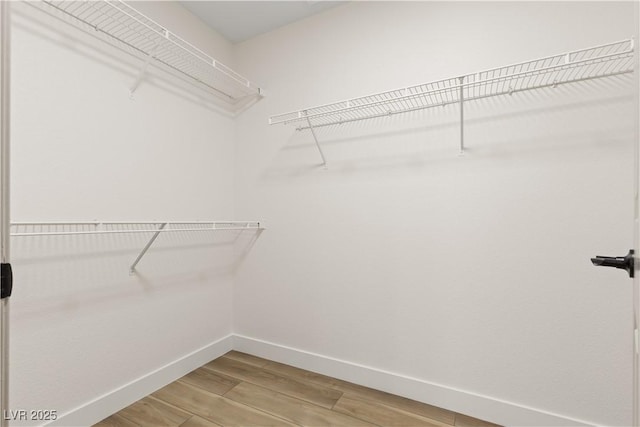 spacious closet featuring hardwood / wood-style flooring