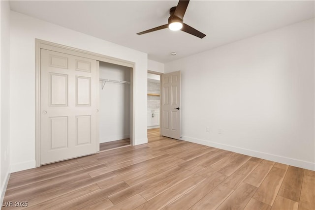 unfurnished bedroom featuring ceiling fan, light hardwood / wood-style flooring, and a closet