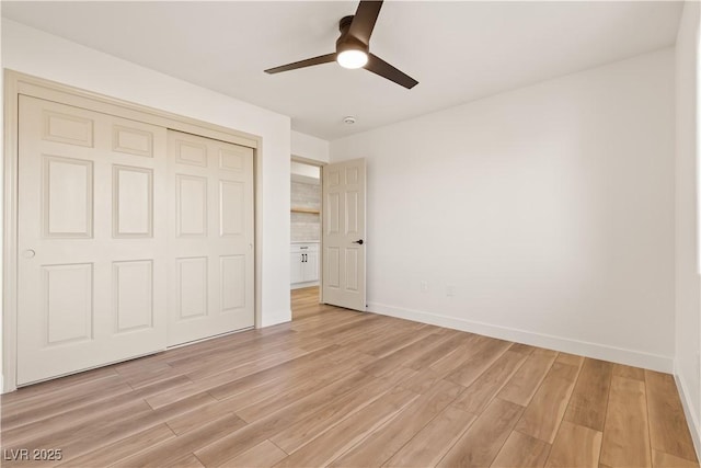 unfurnished bedroom with ceiling fan, a closet, and light hardwood / wood-style flooring