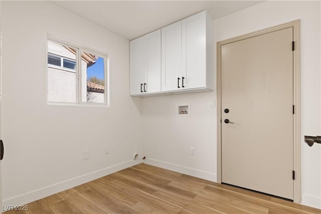 laundry area with washer hookup, cabinets, and light wood-type flooring