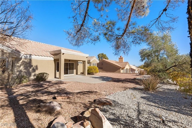 back of property with a patio