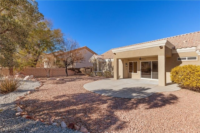 rear view of property featuring a patio area and ceiling fan