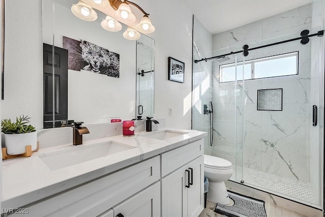 bathroom with toilet, vanity, and a shower with shower door