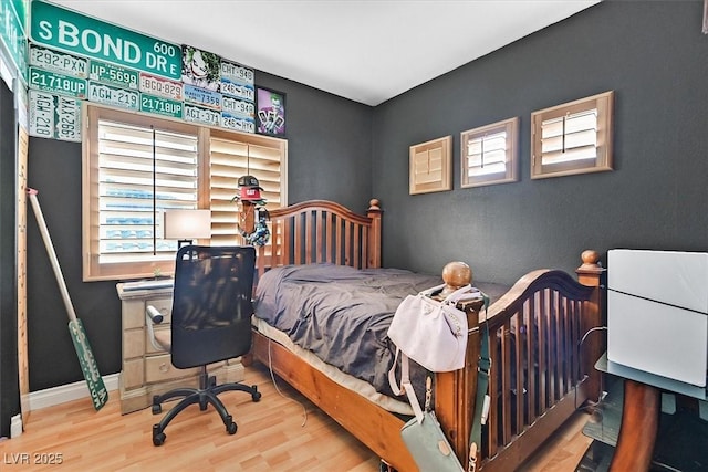 bedroom with hardwood / wood-style flooring