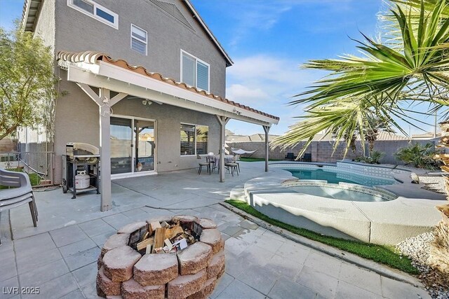 back of property featuring an outdoor fire pit, a patio area, and a fenced in pool