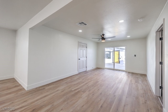 empty room featuring ceiling fan, light wood-type flooring, and a textured ceiling