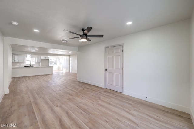 unfurnished living room with ceiling fan and light hardwood / wood-style floors