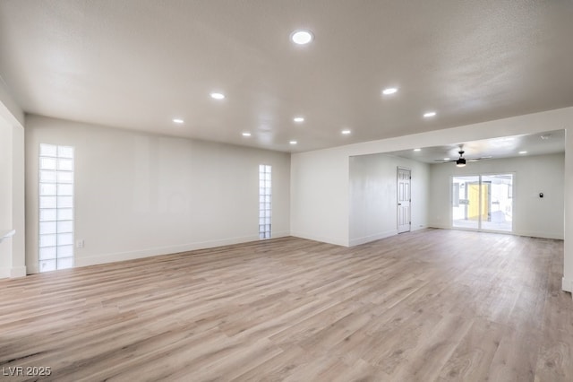 spare room with ceiling fan and light hardwood / wood-style floors