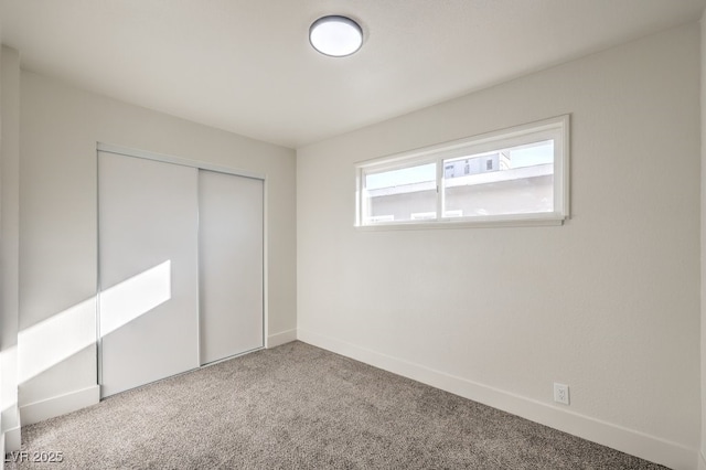 unfurnished bedroom with a closet and carpet