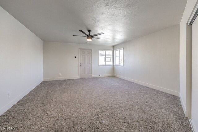 carpeted empty room featuring a textured ceiling and ceiling fan