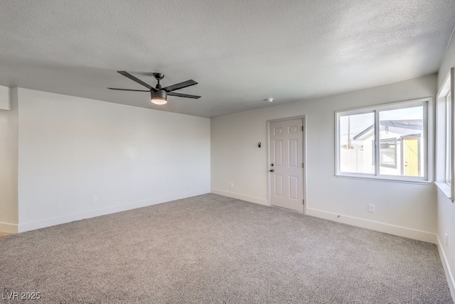 empty room with a textured ceiling, carpet floors, and ceiling fan