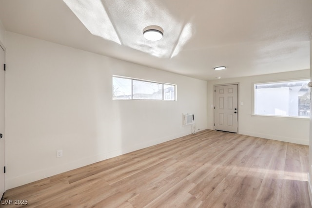 empty room featuring light hardwood / wood-style floors and a textured ceiling