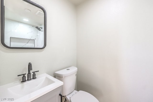 bathroom featuring toilet and vanity