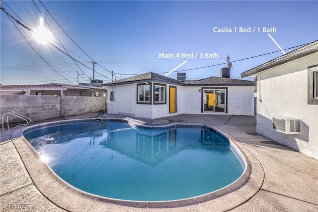 view of pool featuring a patio area and central AC unit