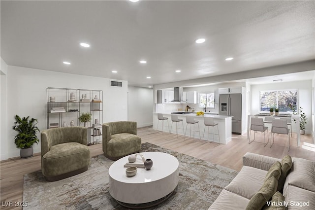 living room featuring light hardwood / wood-style floors and sink