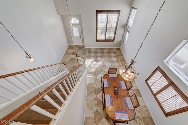 foyer featuring a towering ceiling and a chandelier