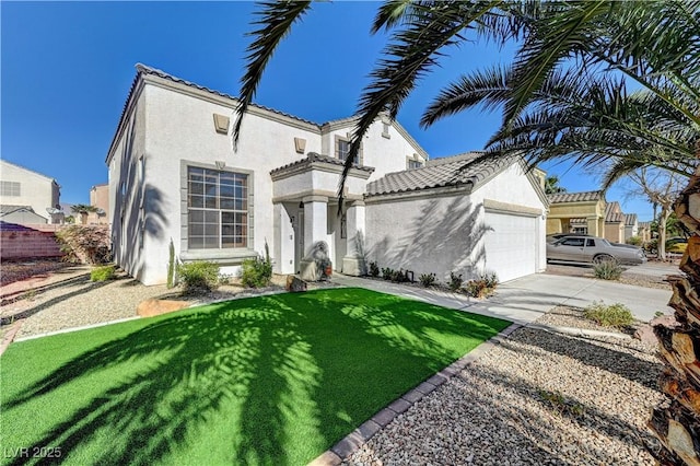 mediterranean / spanish home featuring a front yard and a garage