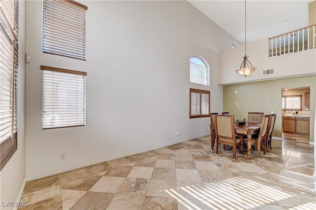 dining space featuring high vaulted ceiling and a wealth of natural light