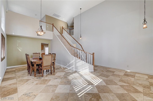 dining area featuring a high ceiling