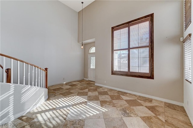 foyer featuring high vaulted ceiling