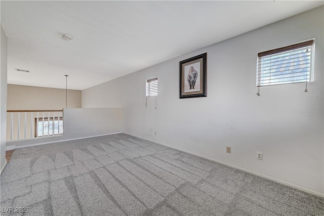 spare room featuring a healthy amount of sunlight and carpet flooring