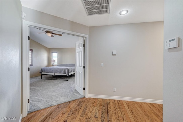 corridor with light hardwood / wood-style flooring