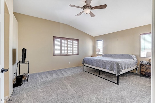 carpeted bedroom with vaulted ceiling and ceiling fan