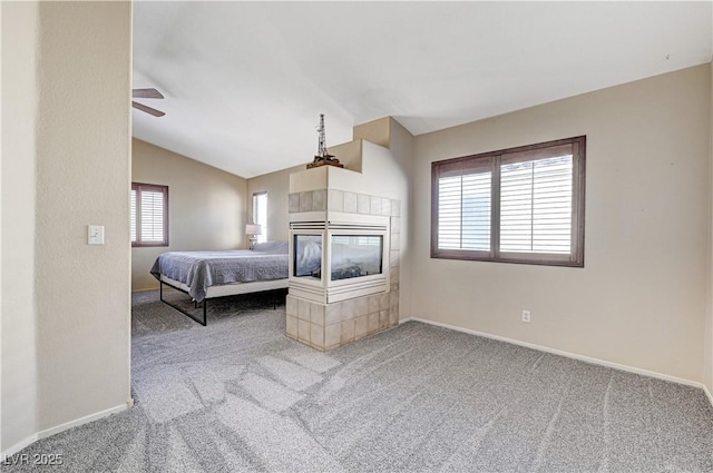 unfurnished bedroom featuring ceiling fan, vaulted ceiling, and carpet