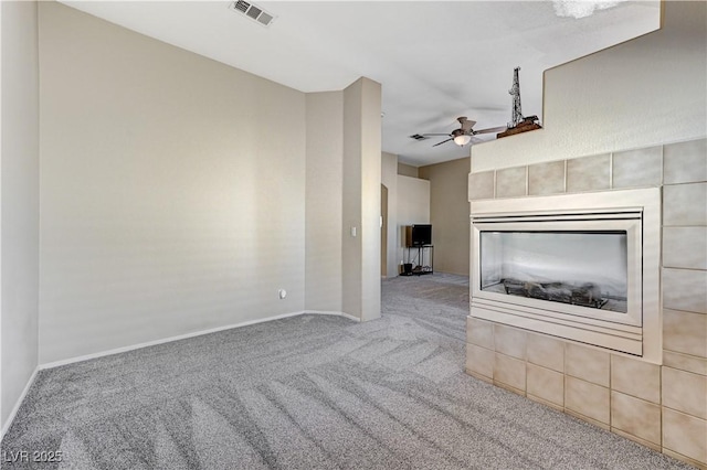 unfurnished living room featuring ceiling fan and carpet