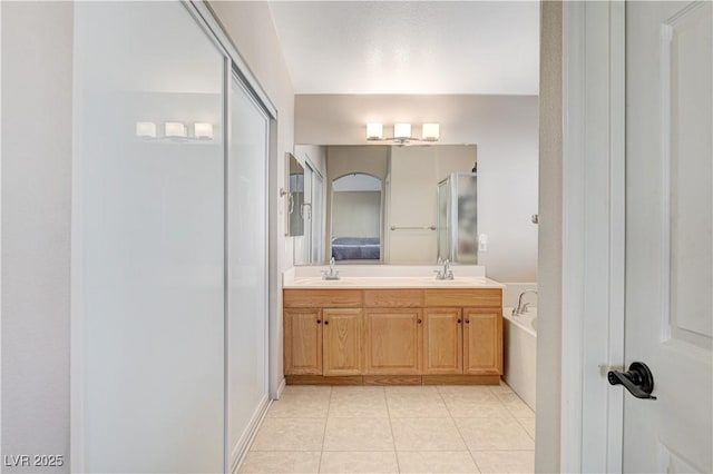 bathroom with tile patterned flooring, plus walk in shower, and vanity