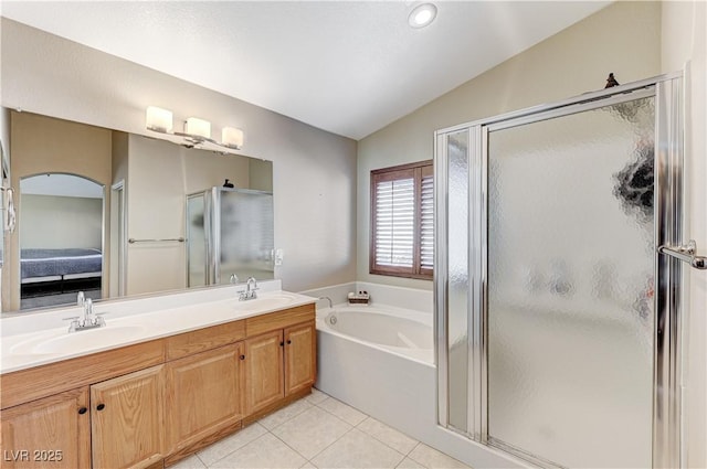 bathroom featuring plus walk in shower, tile patterned flooring, lofted ceiling, and vanity