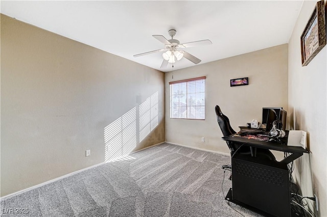 carpeted office space featuring ceiling fan