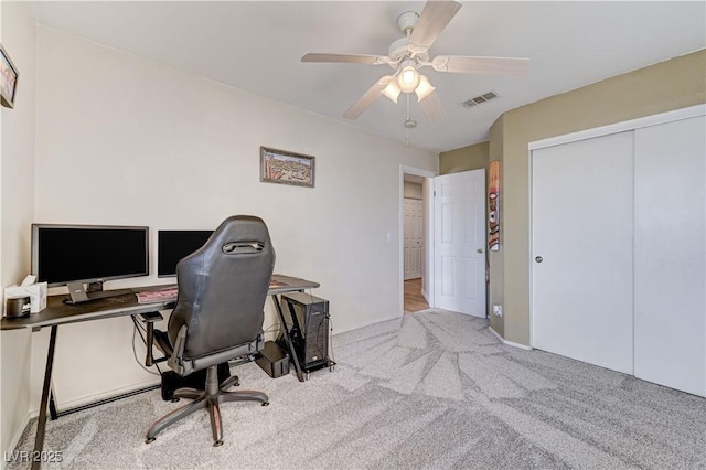 office space with ceiling fan and light colored carpet