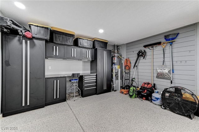 garage with wooden walls and gas water heater