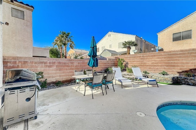 view of patio / terrace featuring a pool and grilling area