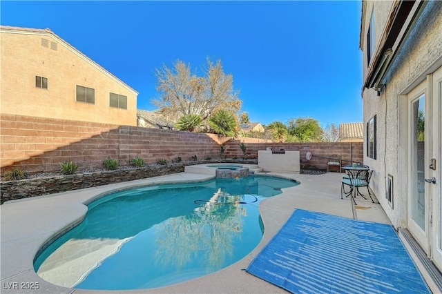 view of pool featuring a patio and an in ground hot tub