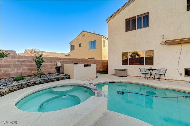 view of pool with an in ground hot tub