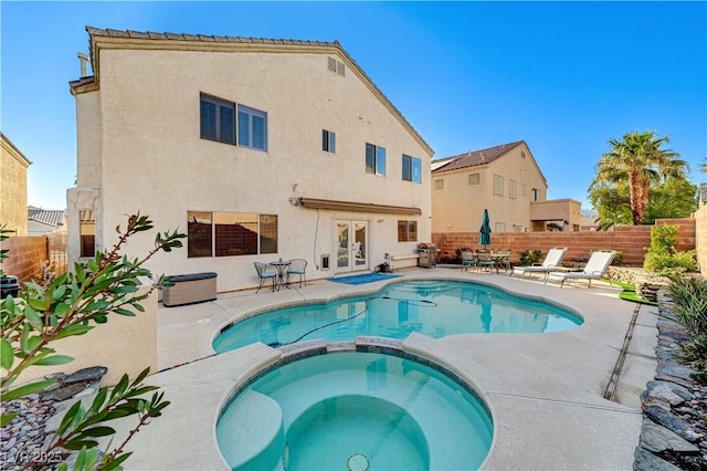 view of pool featuring a patio and an in ground hot tub